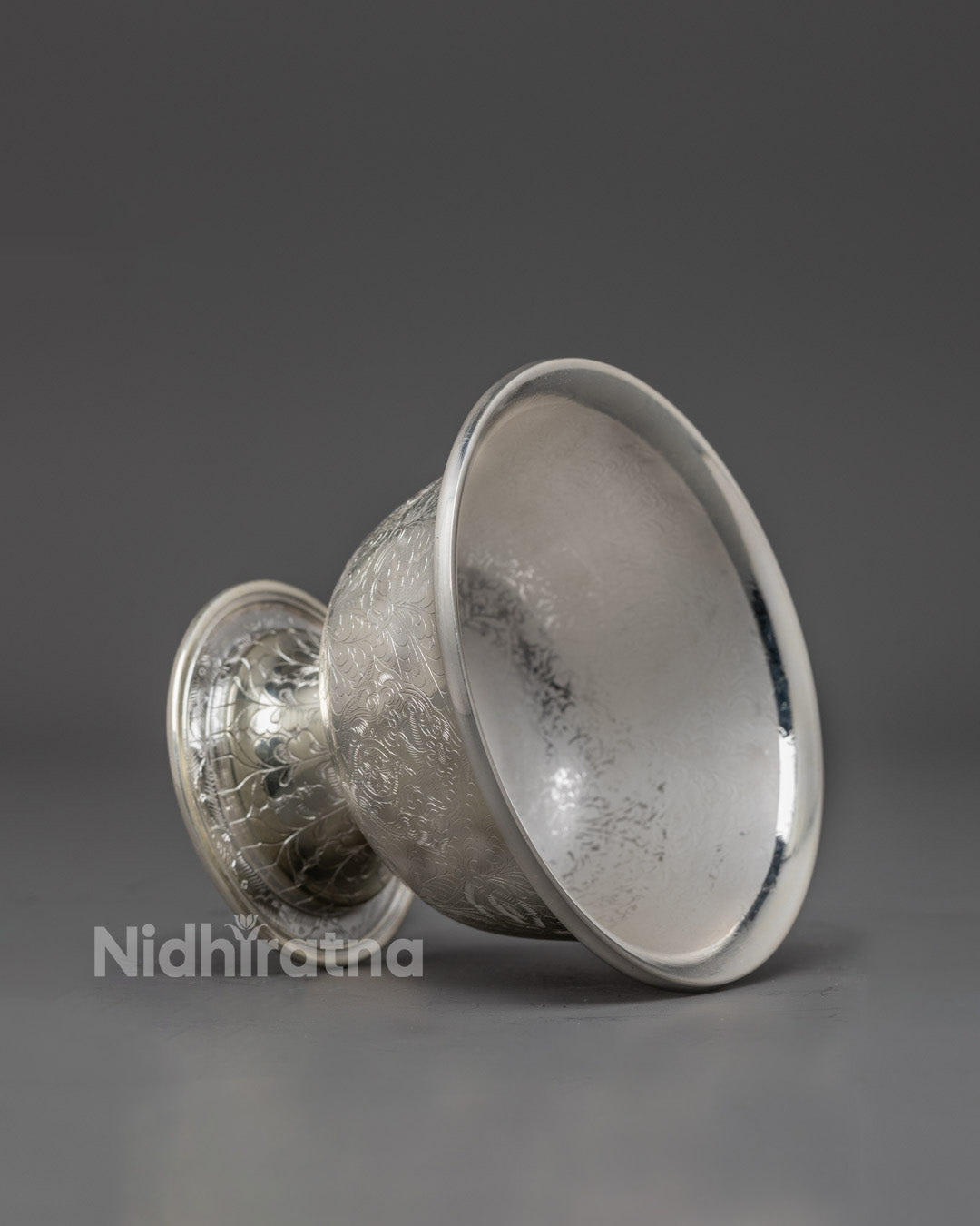 Side angle of pure silver water offering bowl showcasing detailed craftsmanship