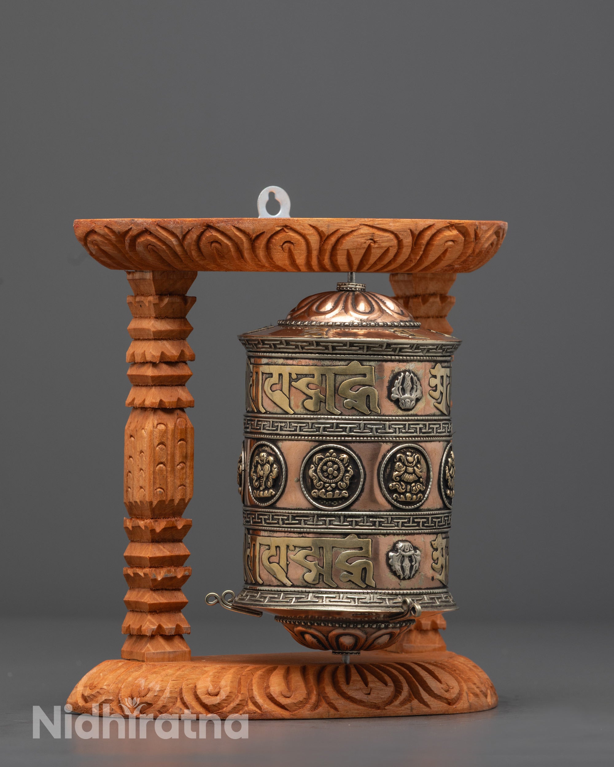 Side angle of sacred Buddhist Mantra Prayer Wheel with engraved mantras and auspicious symbols