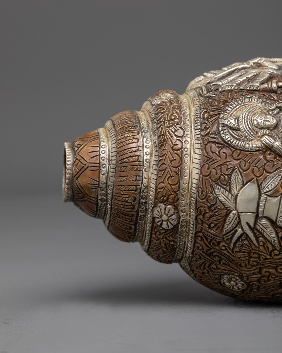 Side angle of sacred Durga Shankh showing filigree and deities, perfect for tantric rituals