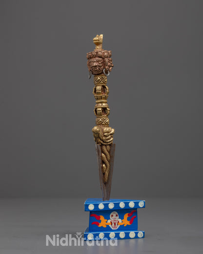 Side angle of sacred Phurba dagger made from copper and iron, used for spiritual protection

