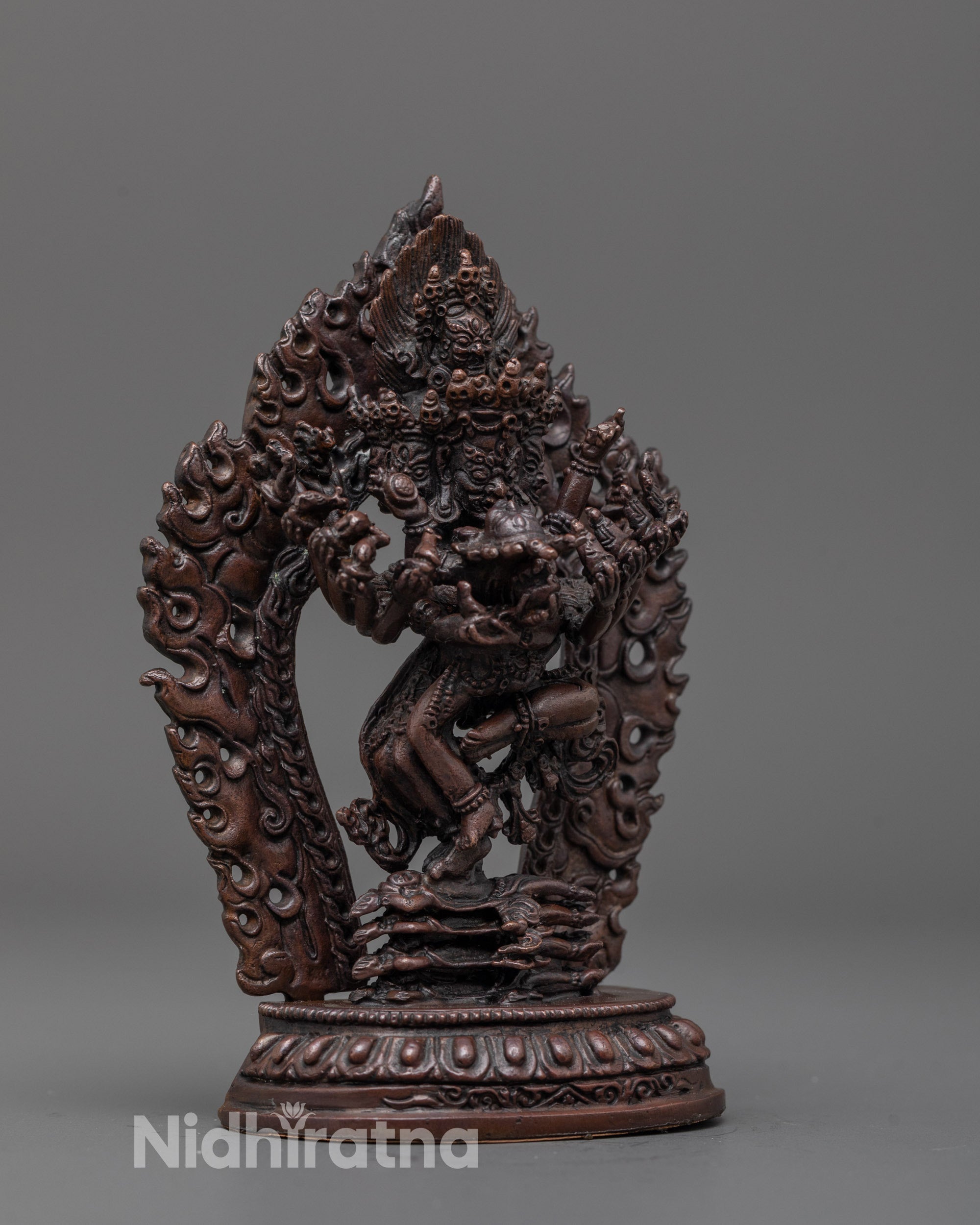 Side angle of the Hevajra statue showing the detailed multiple arms and sacred objects