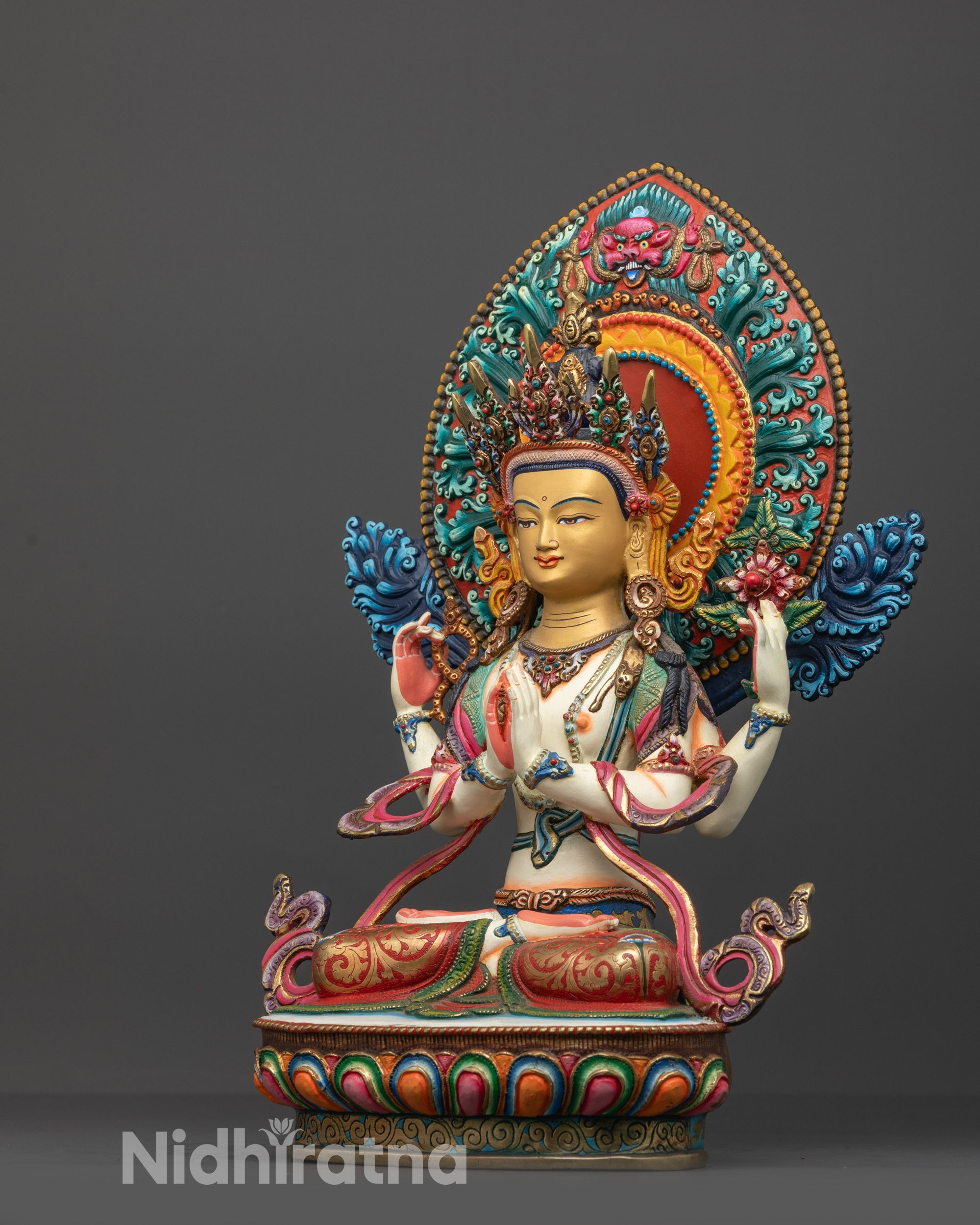 Side angle of the Nepalese Chenrezig statue on its multi colored lotus seat.
