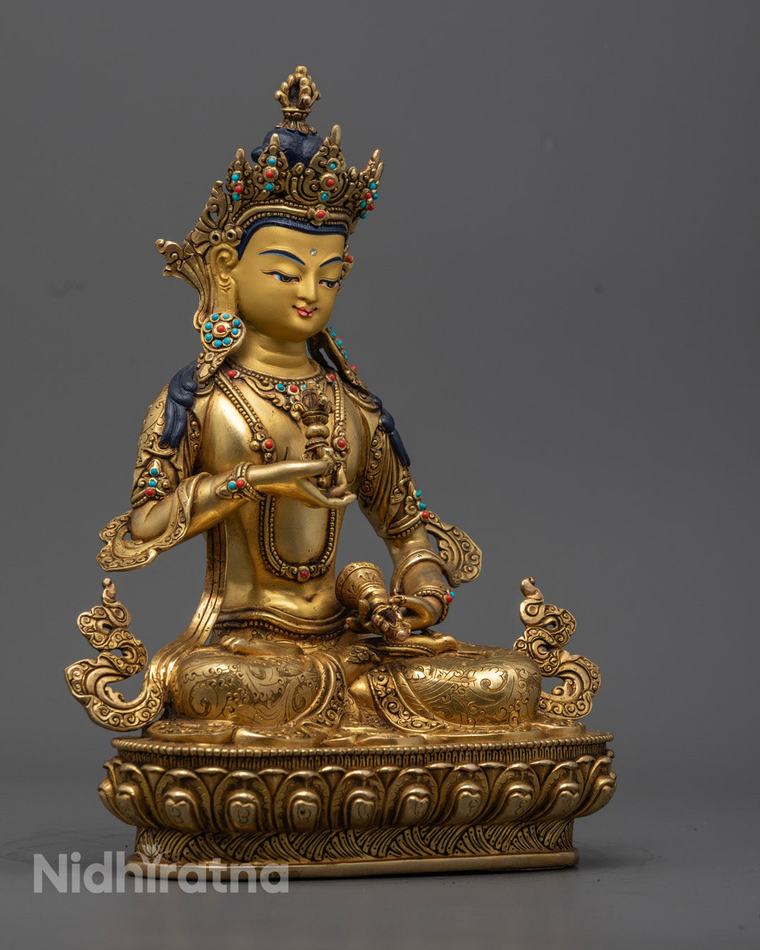 Vajrasattva Statue seated in meditative posture, adorned with vibrant semi-precious stones and radiating peaceful energy.