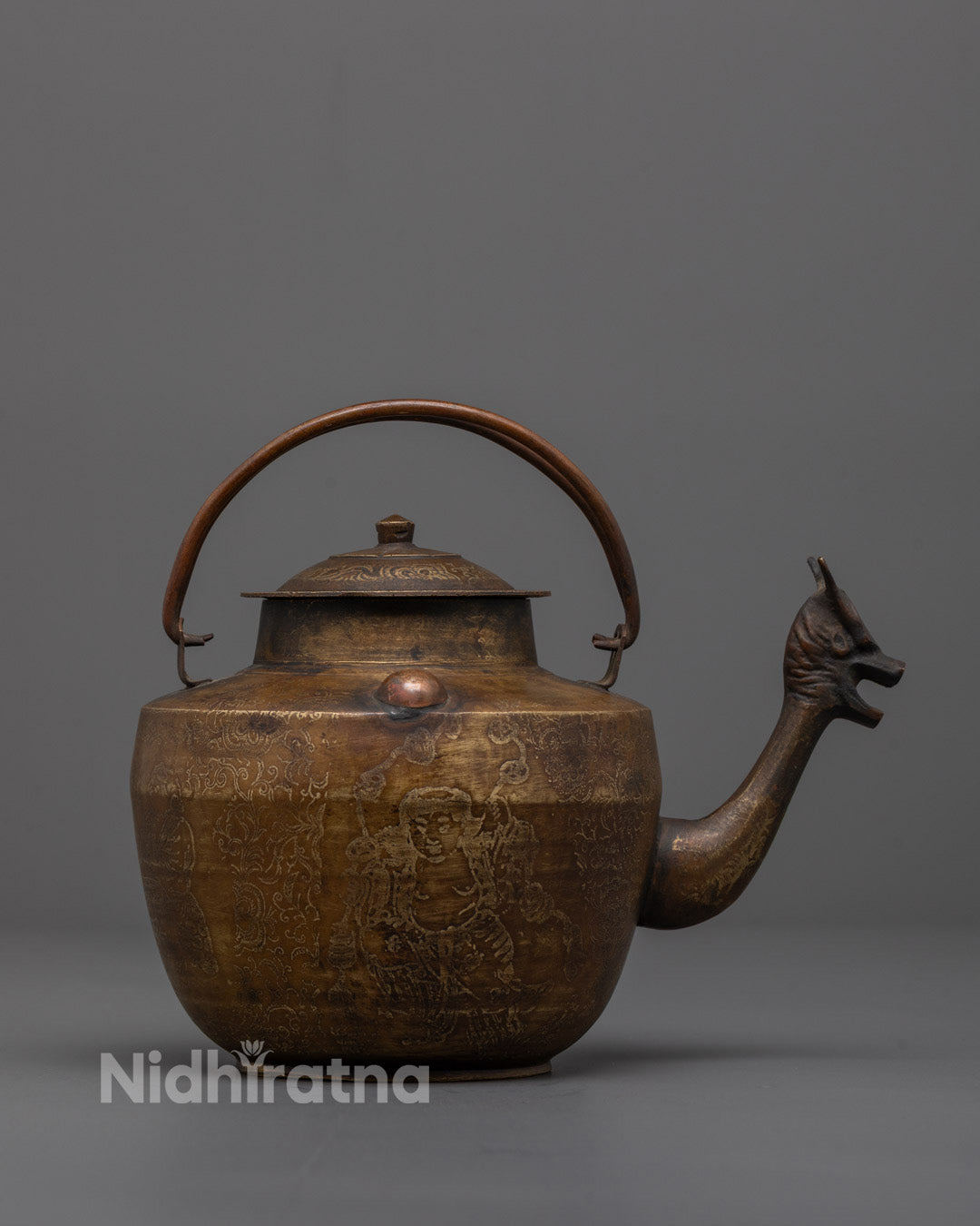 Side angle of traditional brass and bronze Buddhist Tea Pot from Patan, Nepal