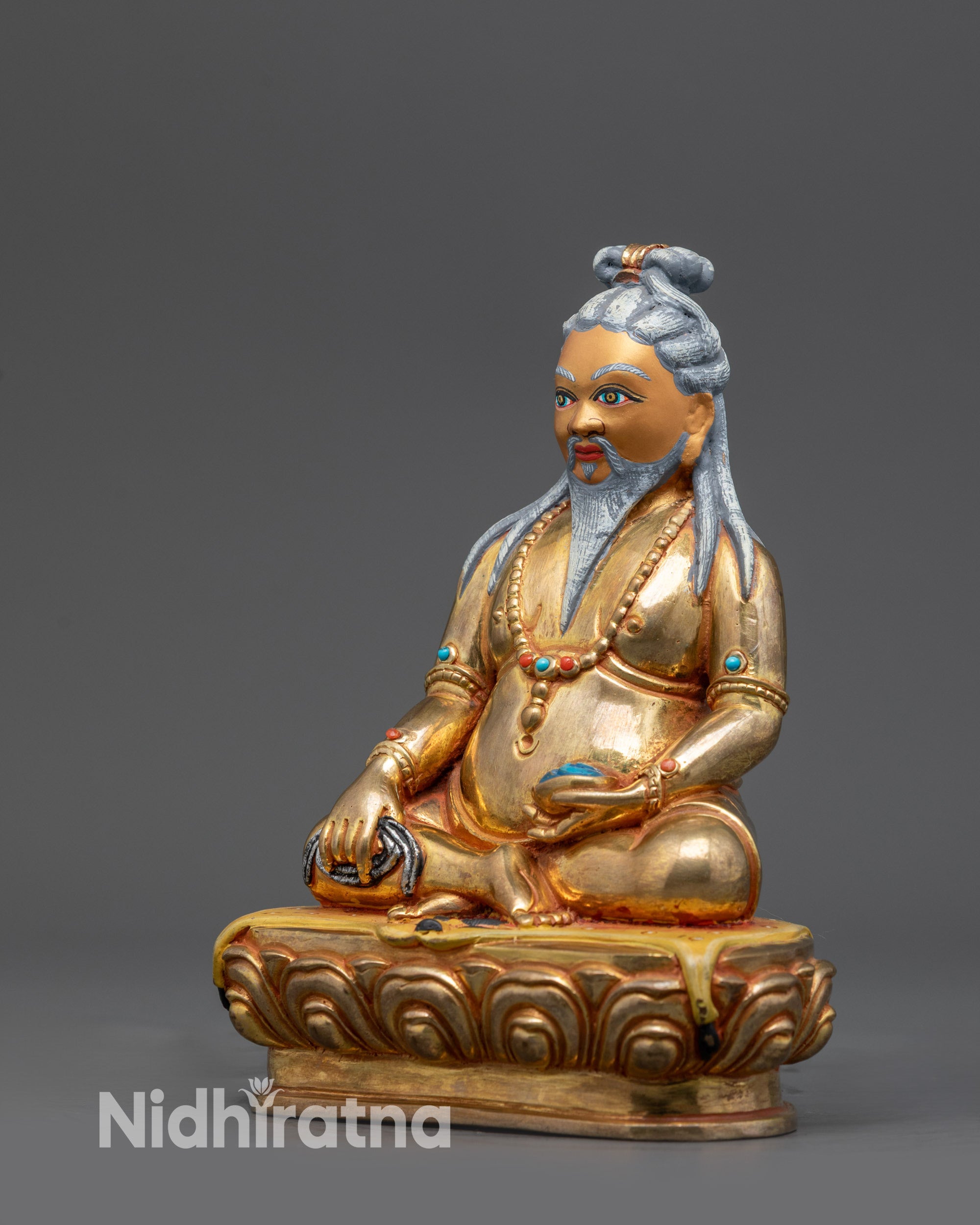 Side angle showing chain, skull cup, and flowing hair of Tibetan Mahasiddha Statue