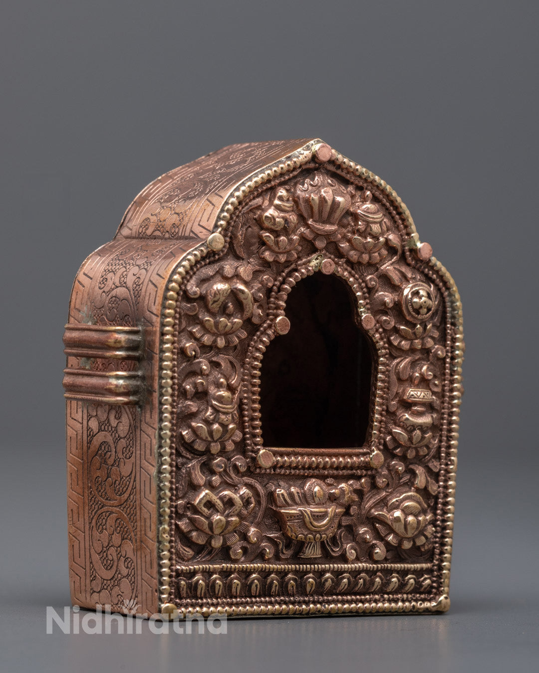 Side angle showing detailed Buddhist symbols on authentic handmade Ghau Box