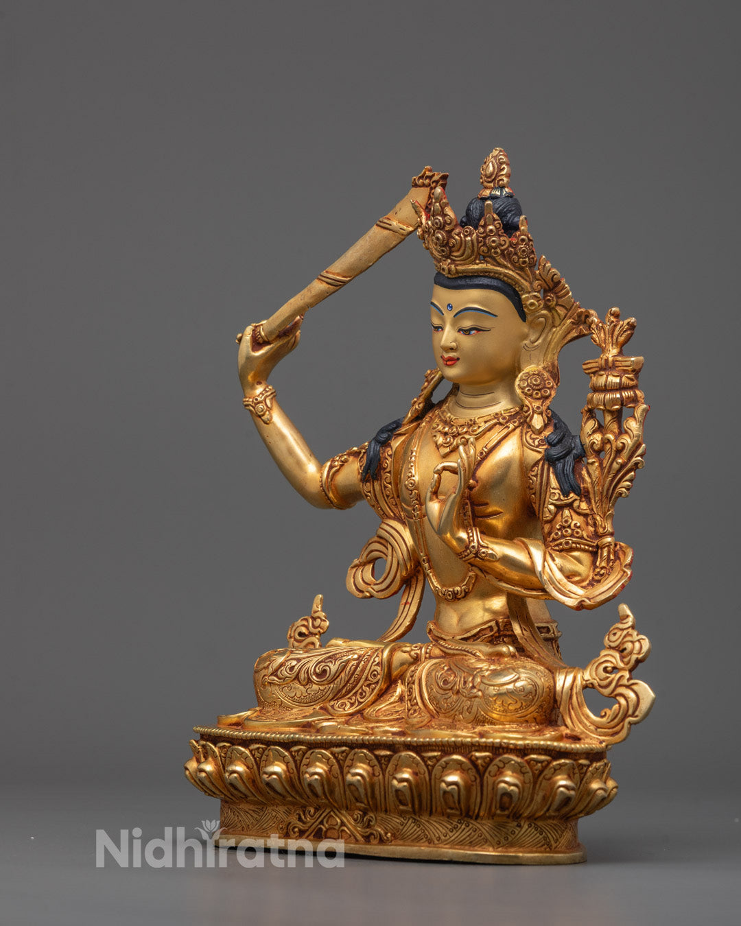 Side angle showing detailed flowing robes, crown, and jewelry on Manjushri Buddha statue