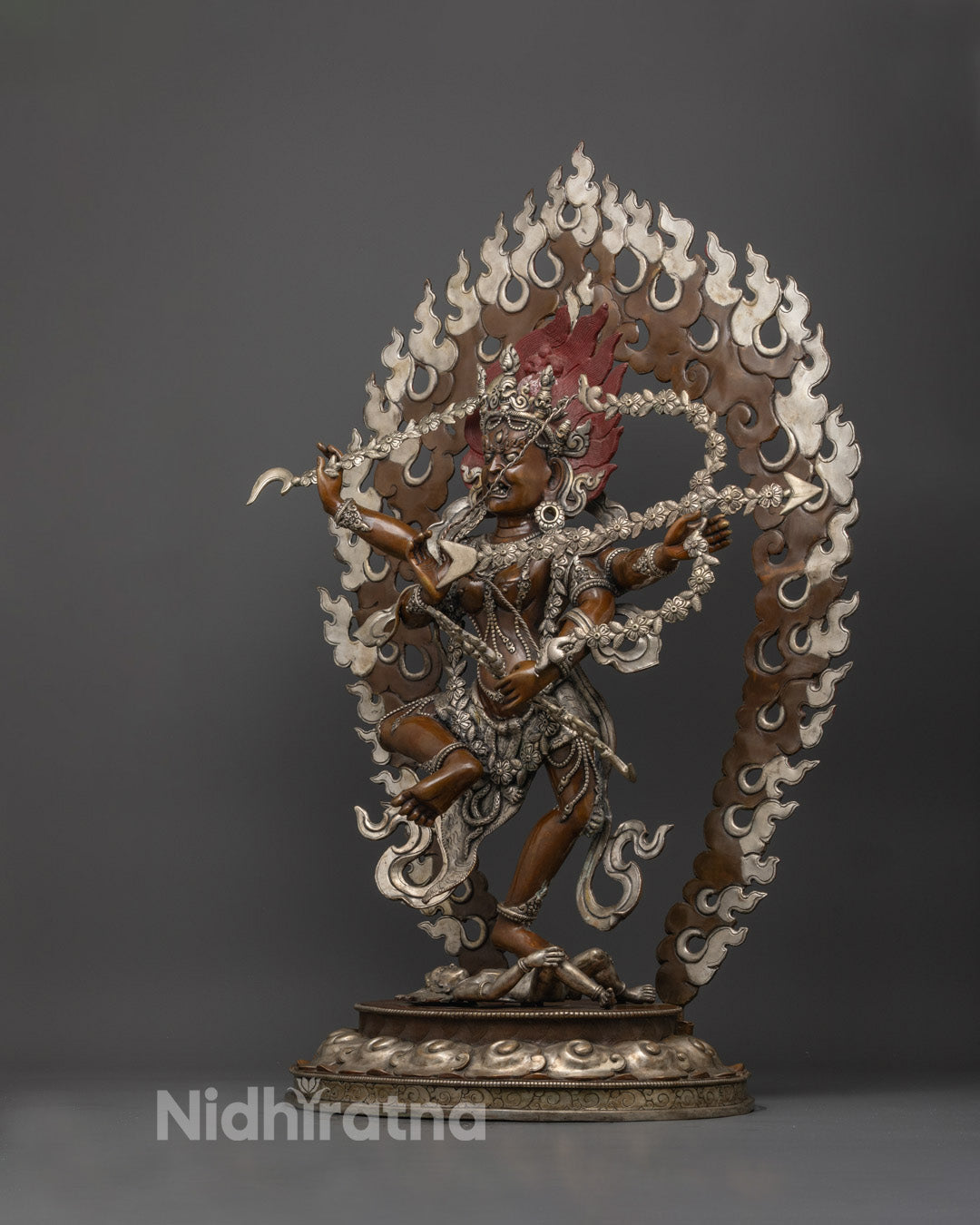 Side angle showing detailed skull crown, flowing robe, and carved jewelry on Kurukulla statue