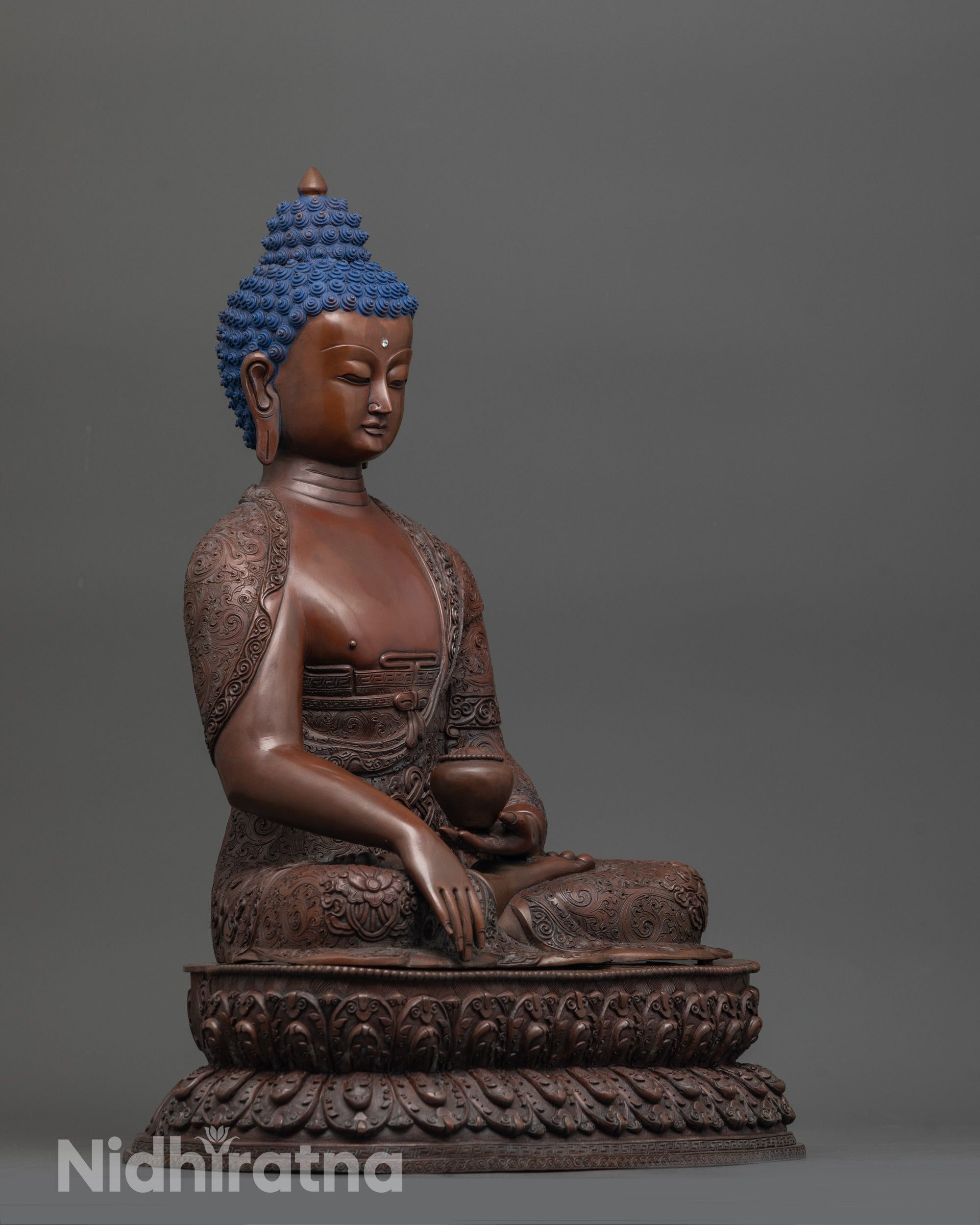 Side angle showing double-layered lotus seat and earthy oxidized copper finish