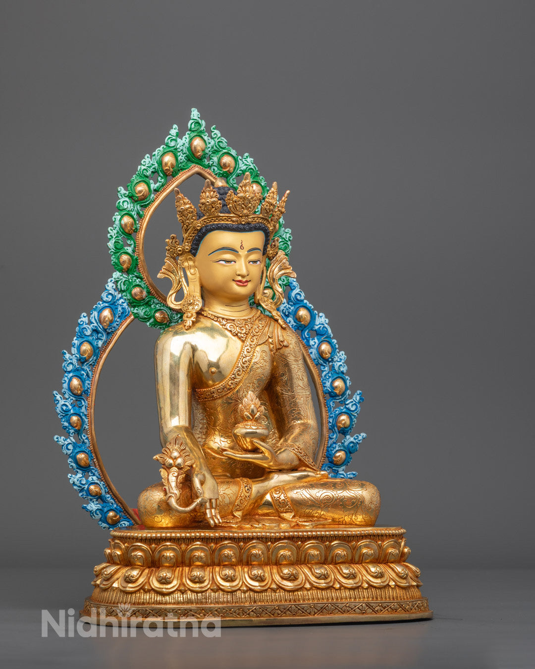 Side angle showing intricate carvings on colored halo and five-jeweled crown of Buddha statue