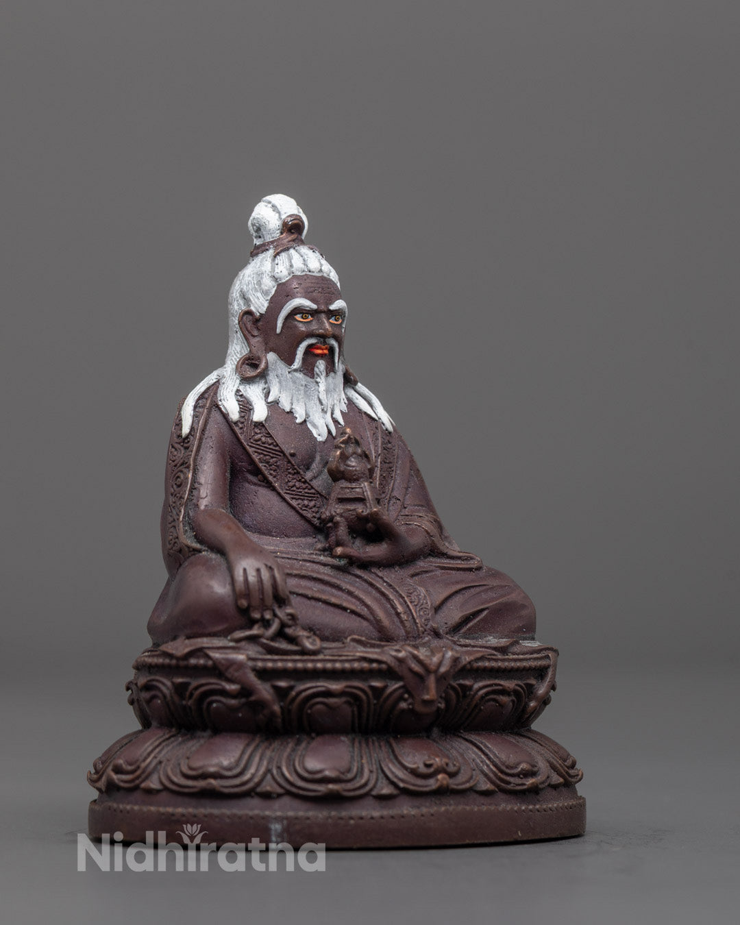 Side angle showing intricate robes and sacred Dharmachakra held by Thang Tong Gyalpo