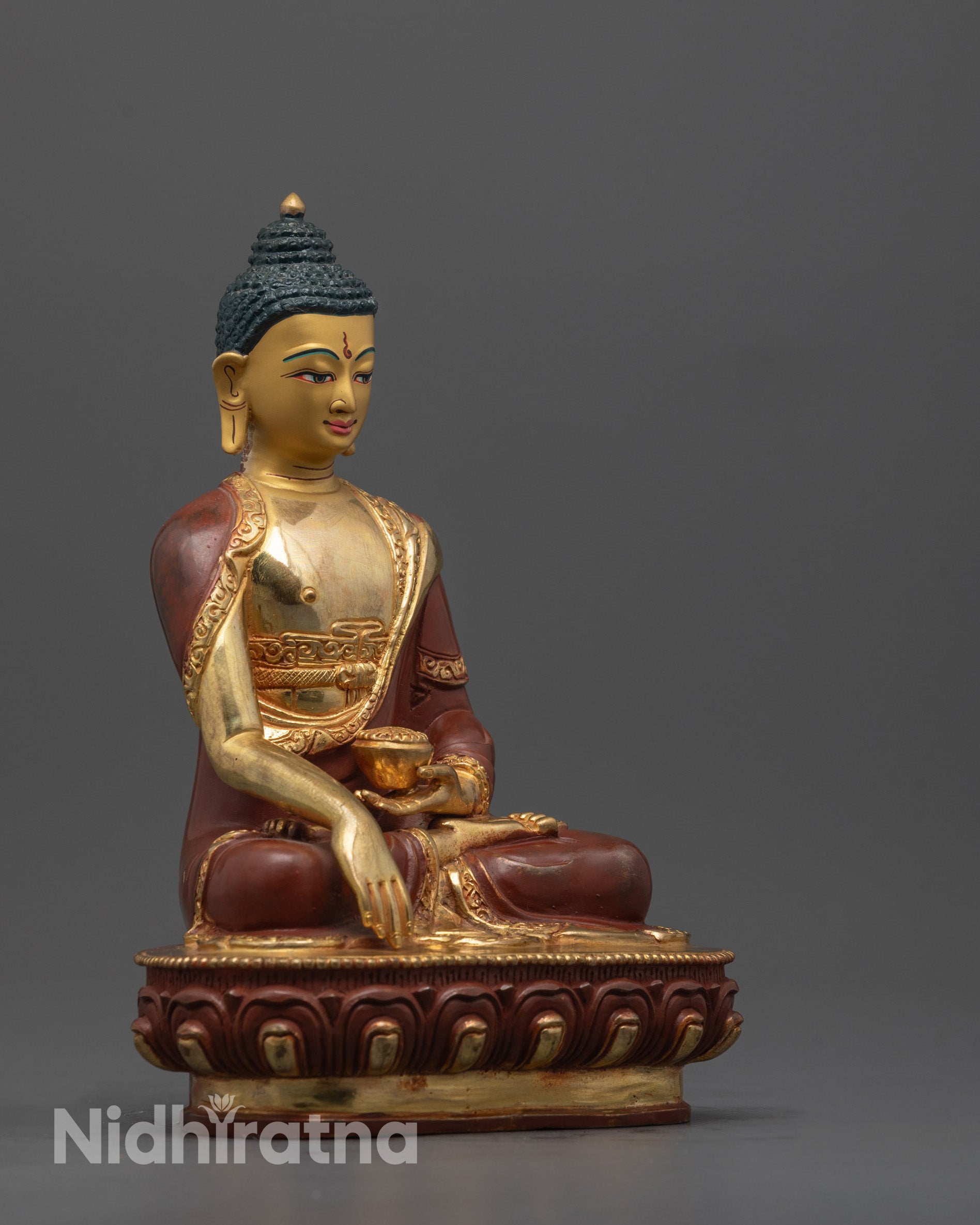 Side angle showing partially gold fire-gilded copper body and carved robe of Buddha