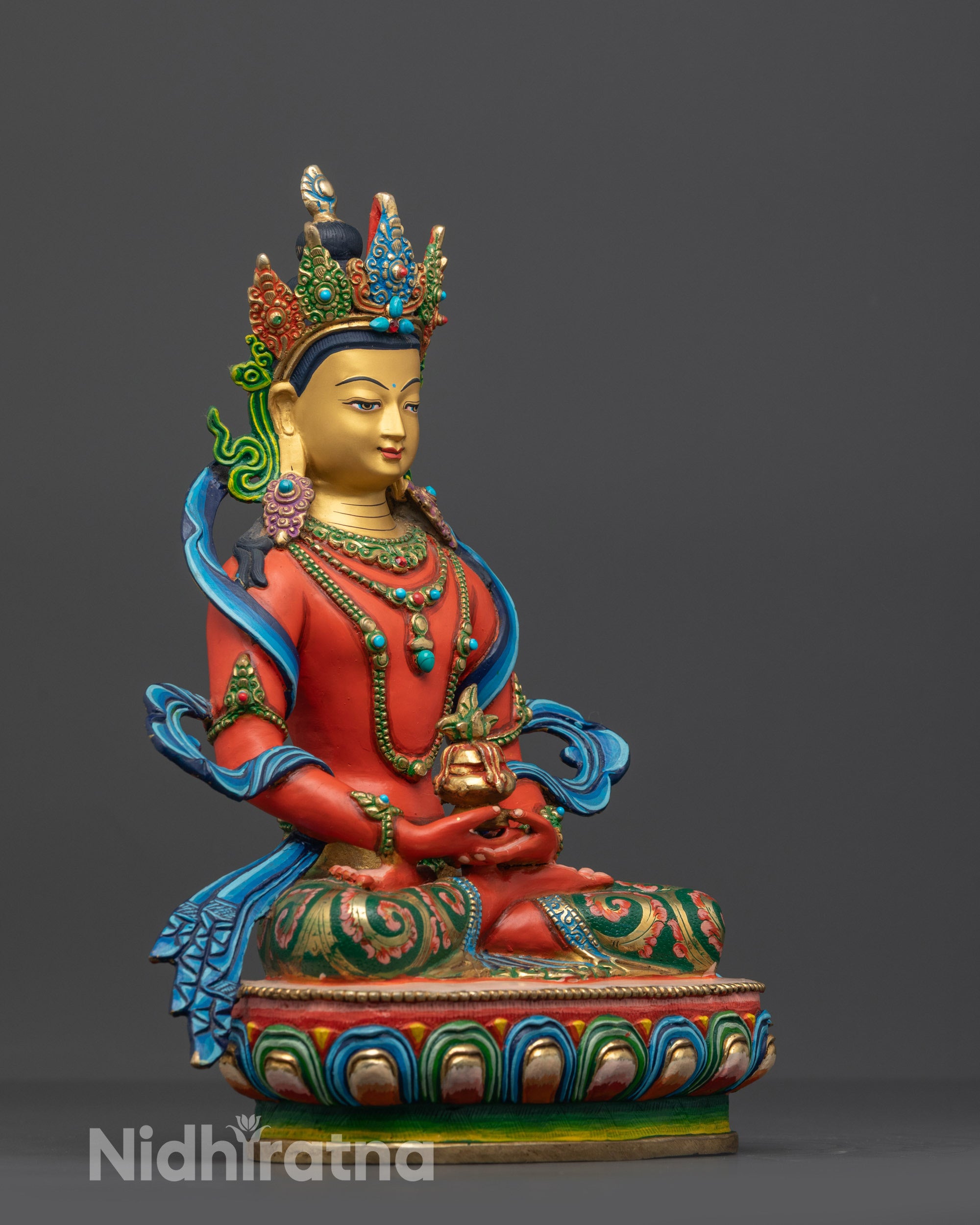 Side angle view of the copper based Amitayus statue showing intricate hand painted details.
