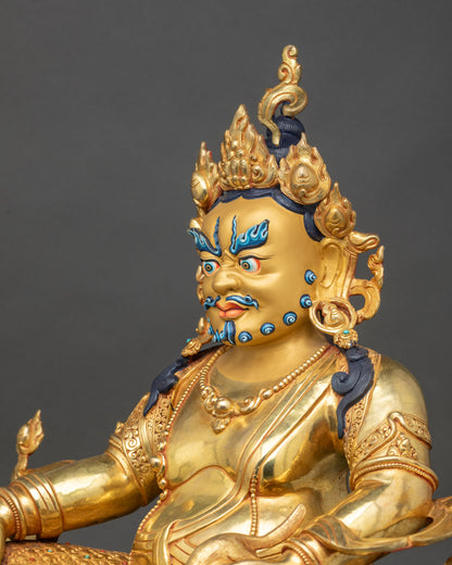 Side close-up of Dzambhala holding citron fruit and jewel-spitting mongoose of abundance