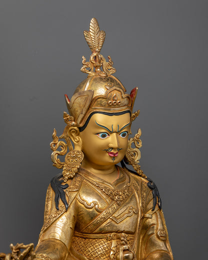 Guru Rinpoche Statue showing detailed craftsmanship, gold-gilded copper body, and vajra in hand.