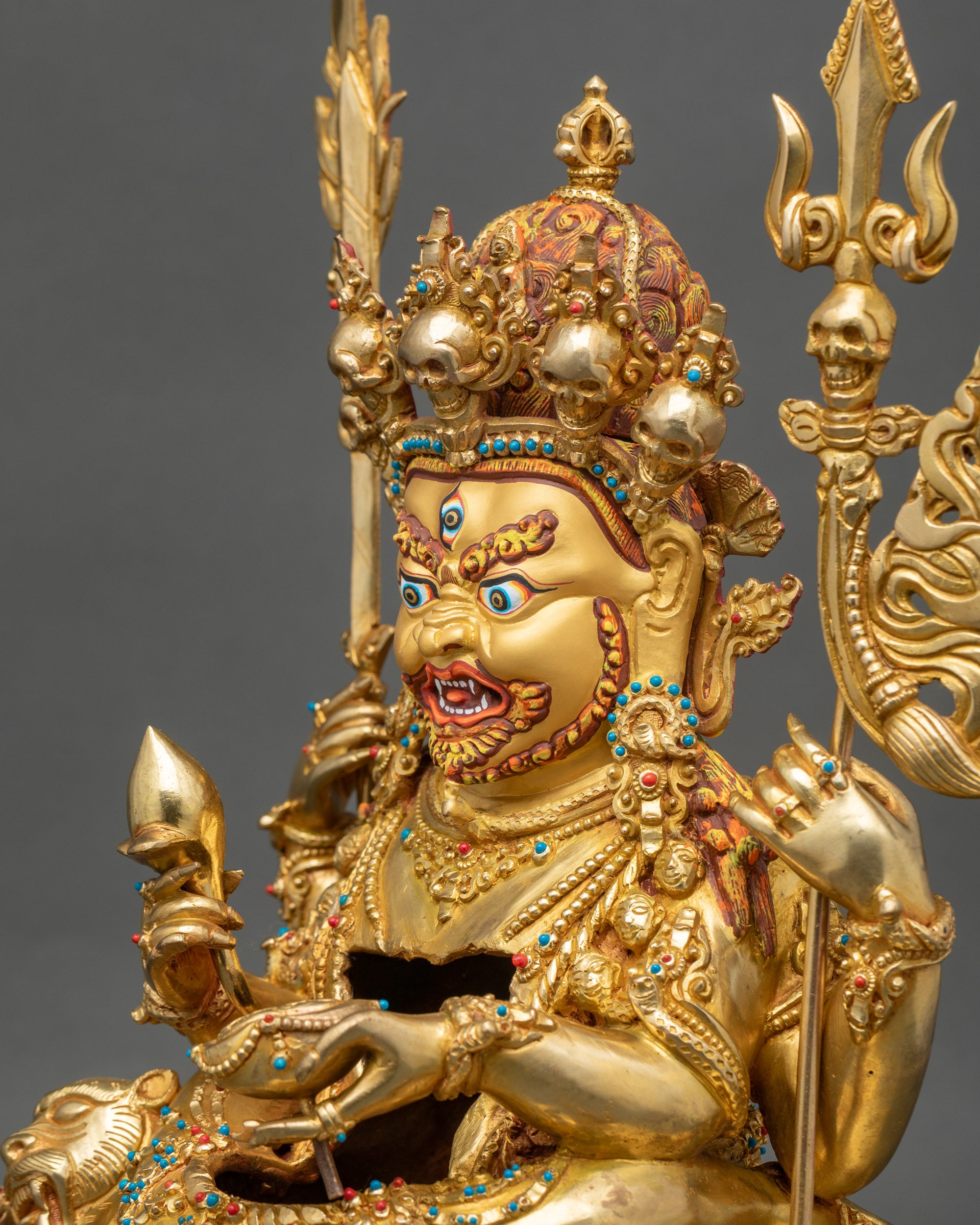 Side close-up of Hayagriva Yab-Yum statue showing four arms and lotus throne