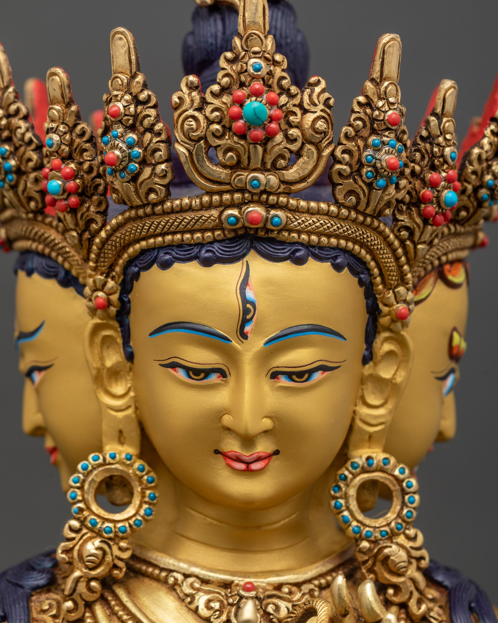 Side close-up of Namgyalma's face with turquoise and coral inlay, detailed craftsmanship