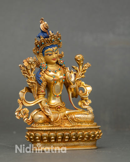 Side close-up of White Tara Bodhisattva seated on lotus throne with gold accents