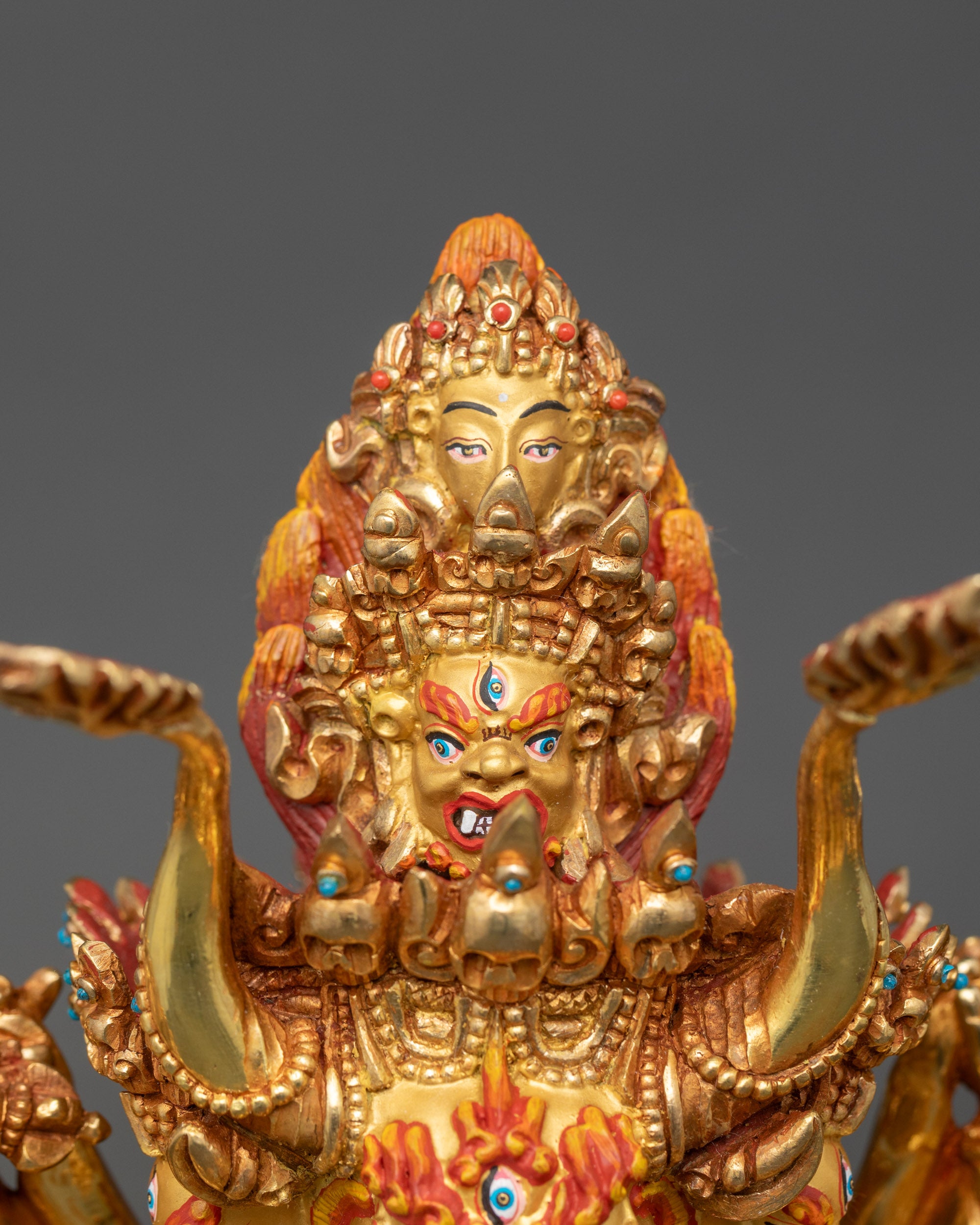 Side close-up of Yamantaka with Consort displaying precise arm carvings and sacred ritual objects
