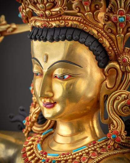 Side close up Maha Manjushri Statue face adorned with five jeweled crown and golden radiance
