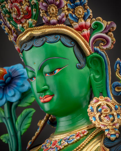 Side close up face Green Tara profile with gold-plated crown and facial details