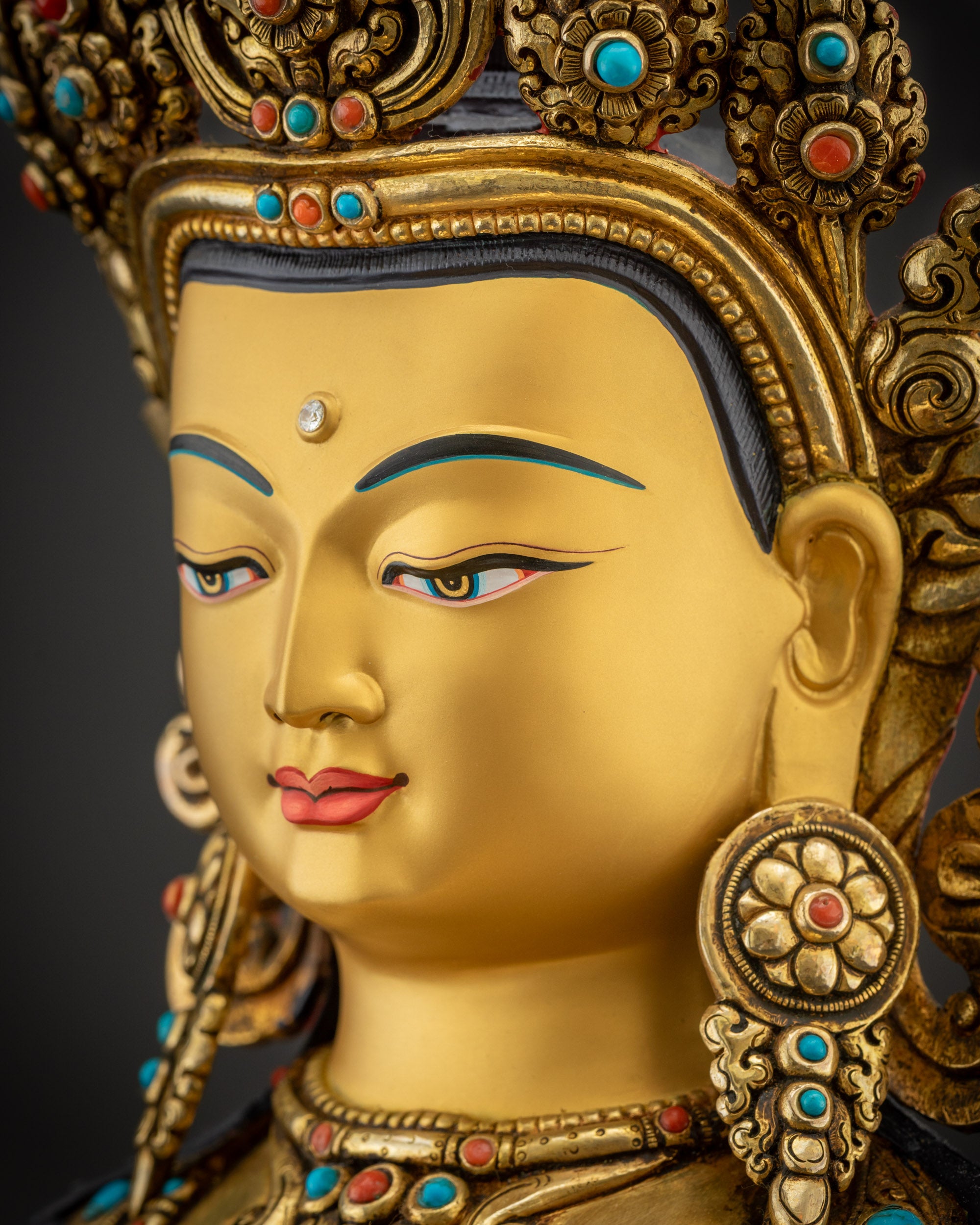 Side close up face Vajrasattva statue showing calm expression and ornate crown
