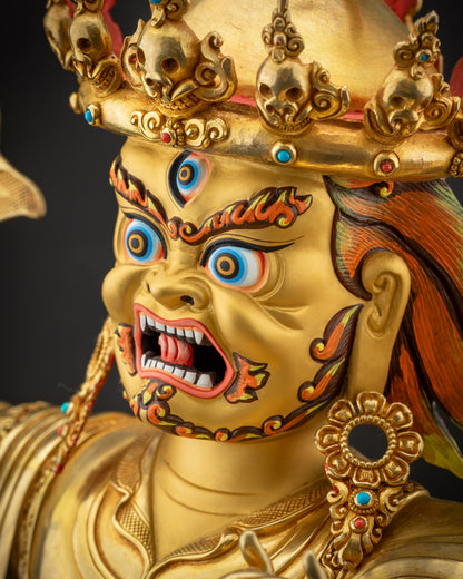 Side close up face of Nechung Chuyong Statue with intricate earrings and skull crown
