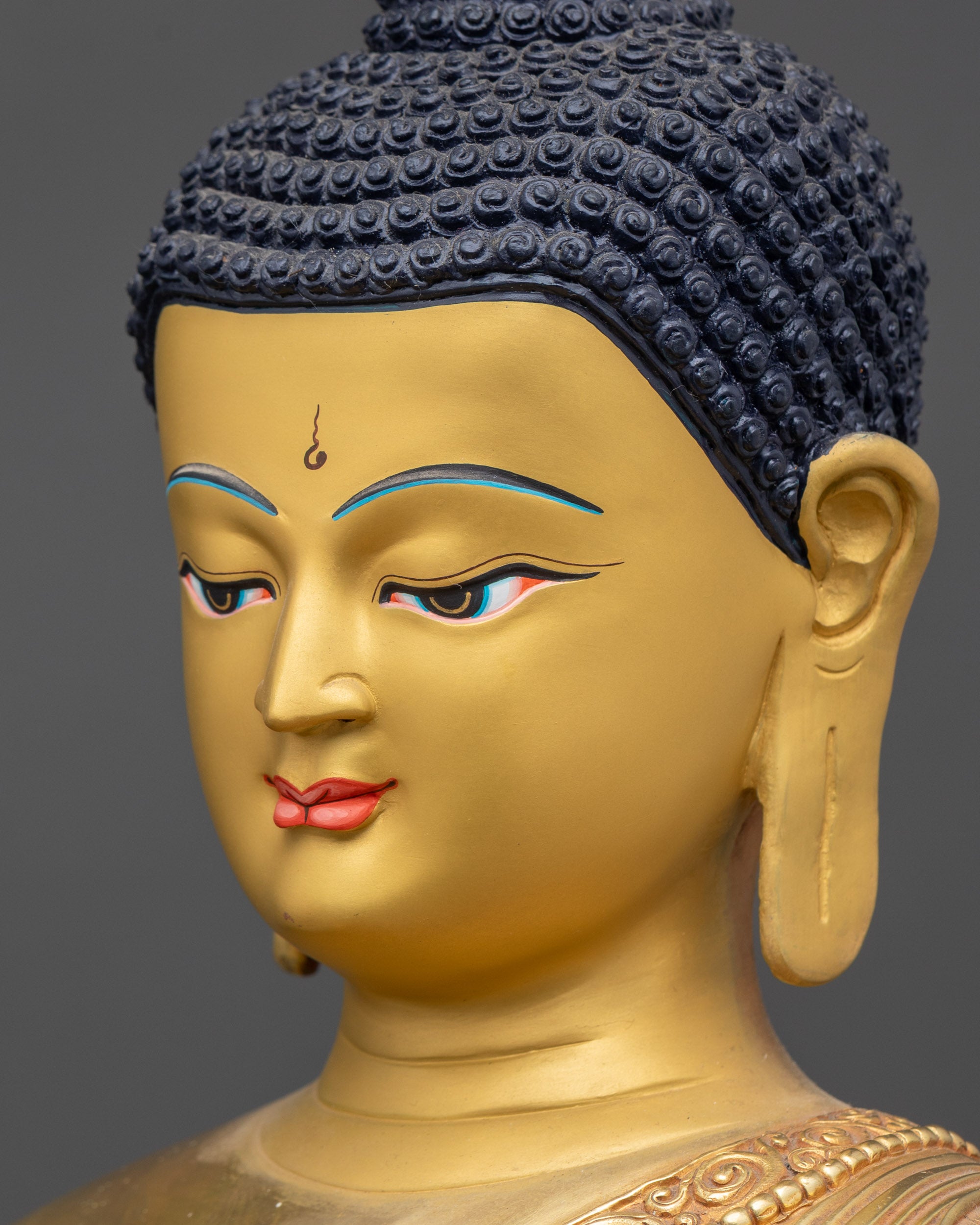 Side close up face of Shakyamuni Buddha with calm expression and golden details
