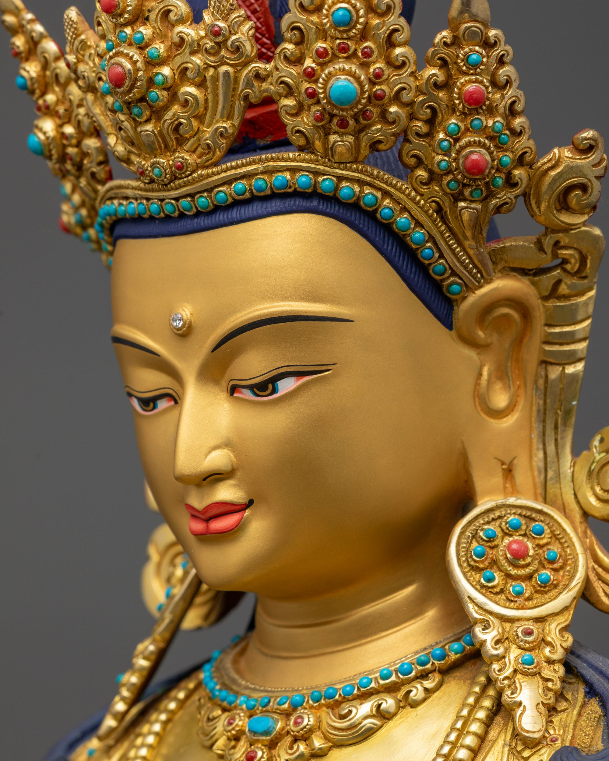 Side close up of Amitayus Buddha face showing serene gold-gilded expression
