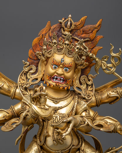 Side close up of Mahakala statue showing six arms and swirling robes