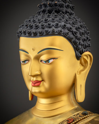 Side close up of Shakyamuni Buddha face showing gold gilded features and soft details
