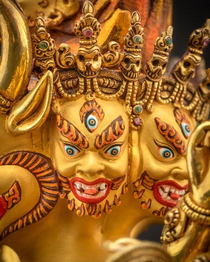Side close up of face showing buffalo head, nine gold-painted faces, skull diadem, and wrathful expression