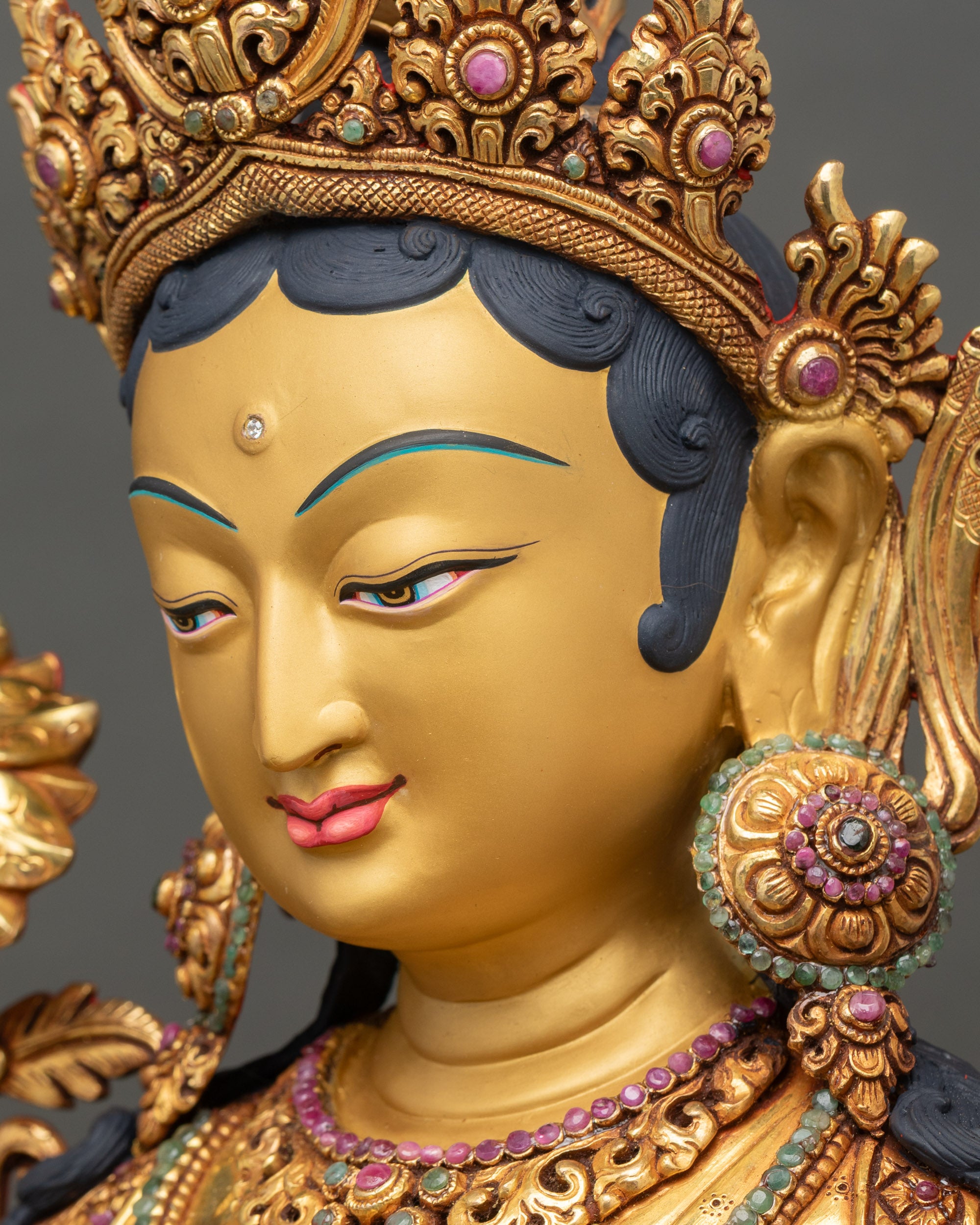 Side close up of her face with radiant gold accents and meditative expression