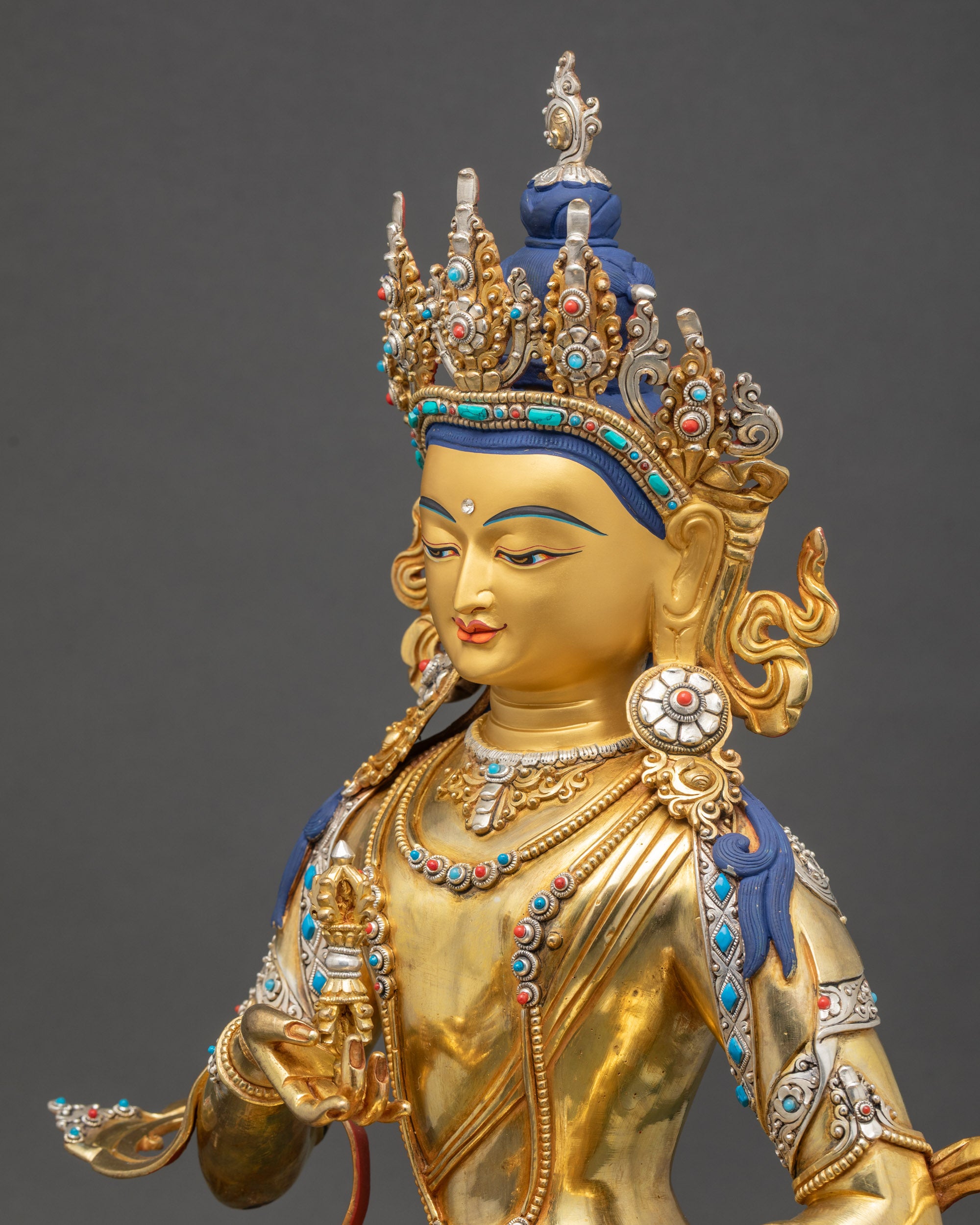 Side close up showing Dorje and Ghanta in gold-gilded meditation statue