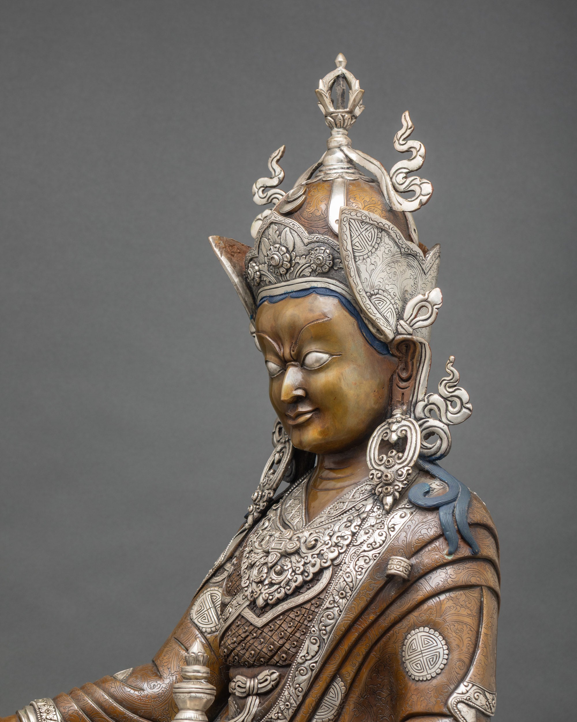 Side detail Padmasambhava statue, silver-plated robes, oxidized copper, hand-carved Nepal