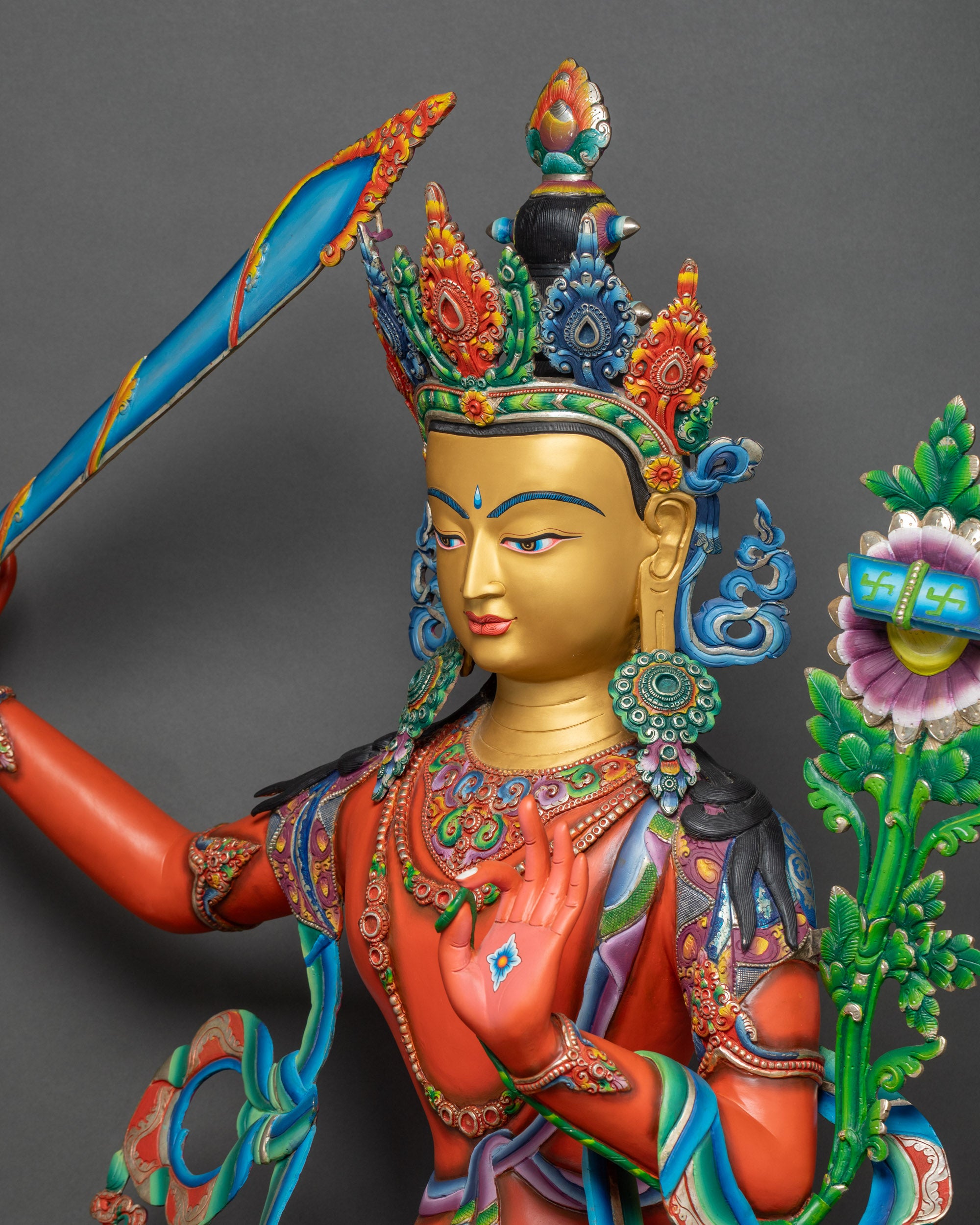Side detail of Manjushri statue highlighting robe patterns and lotus seat design