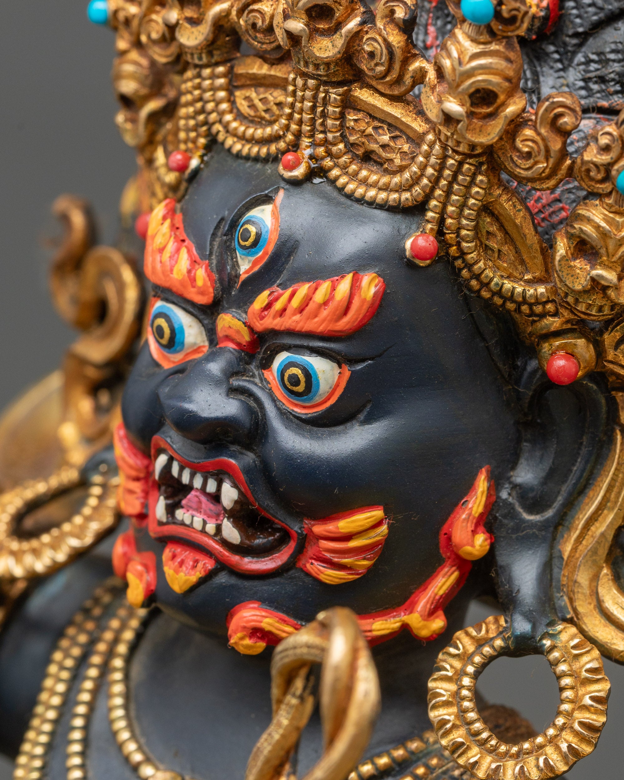Side face close-up of Achala Statue, gold fire-gilded protector deity for meditation altar