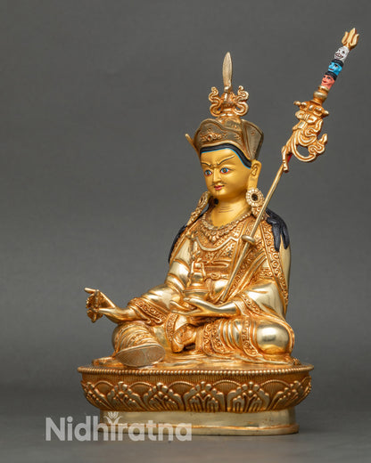 Side face close-up of Padmasambhava statue with lotus hat and kasaya robe