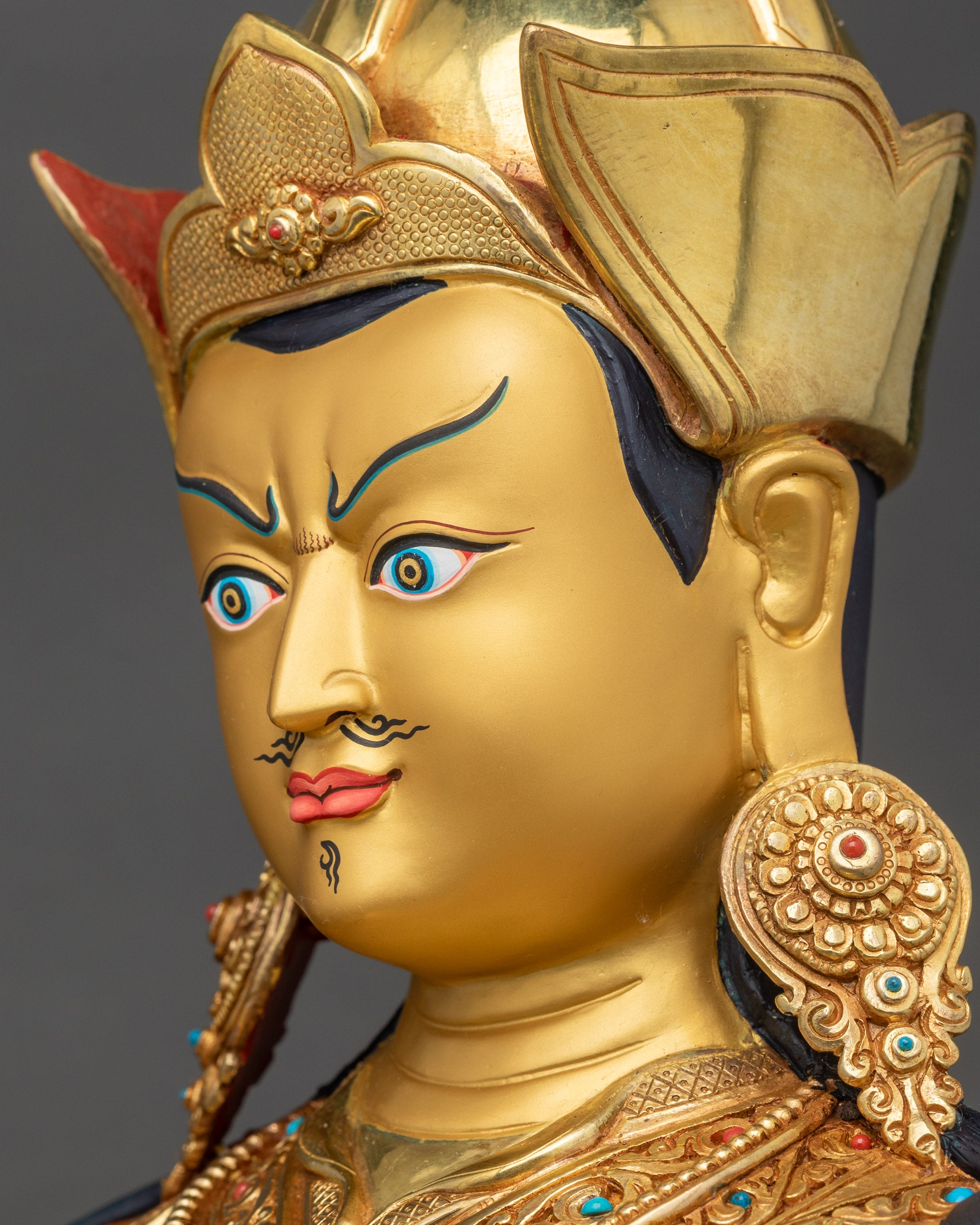 Side face close up of Guru Padmasambhava, gold fire-gilded, intricate Newari artisan details
