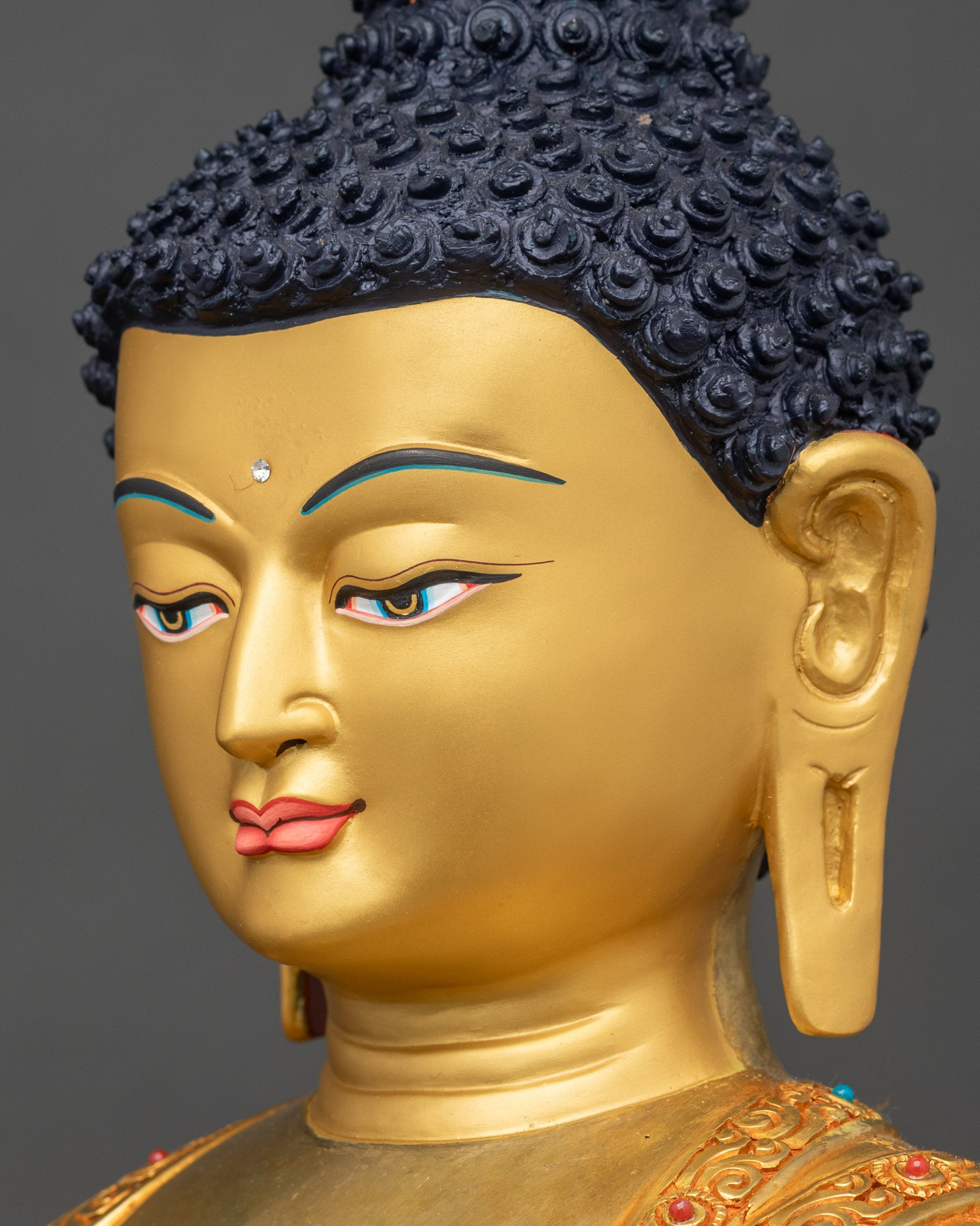 Side face close up of Shakyamuni Buddha serene gold face blue eyes