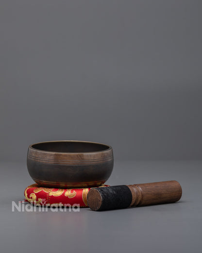 Side image of Singing Bowl set with wooden striker and brocade cushion, perfect for sound therapy