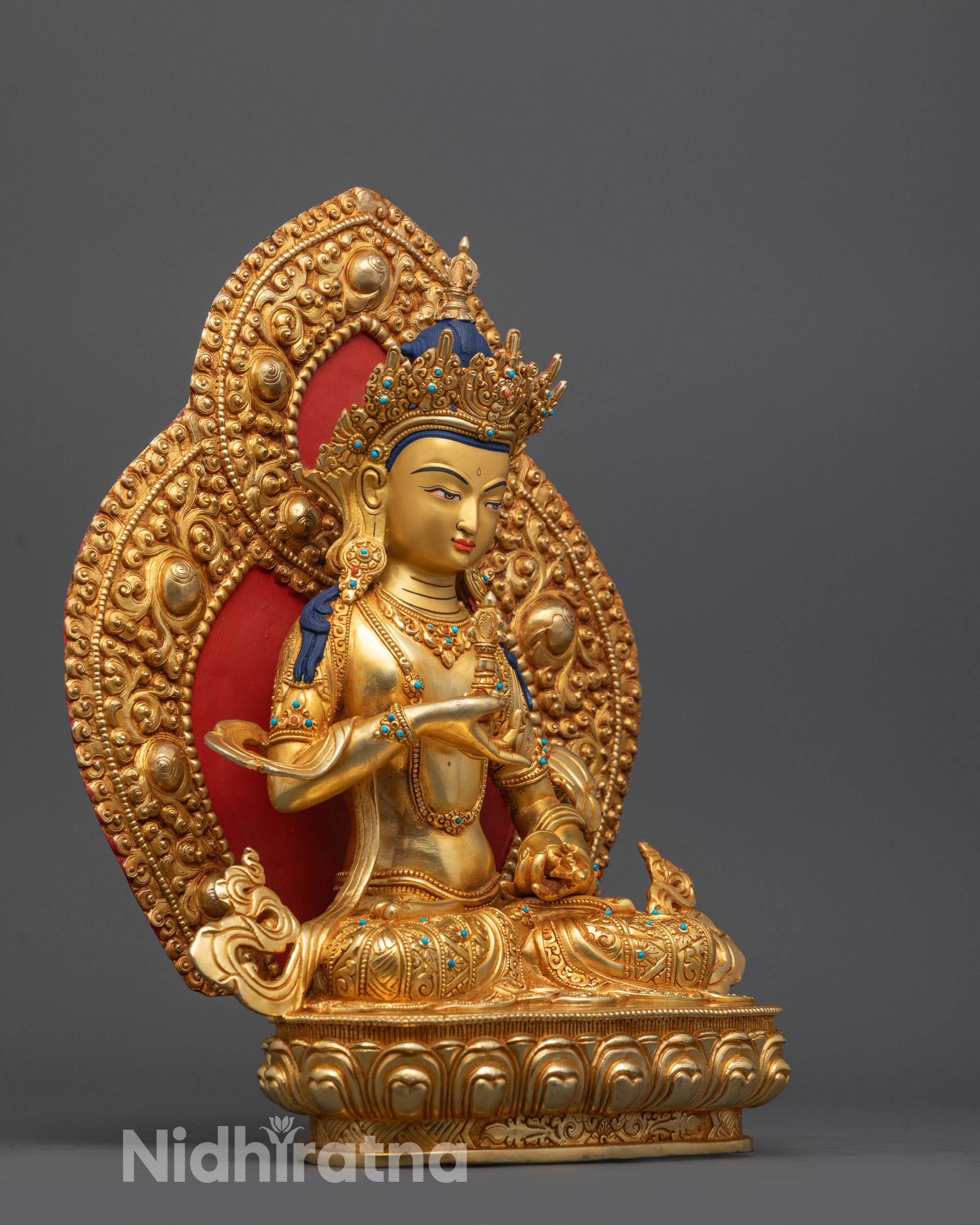 Side perspective of Vajrasattva statue showcasing the sacred vajra and bell
