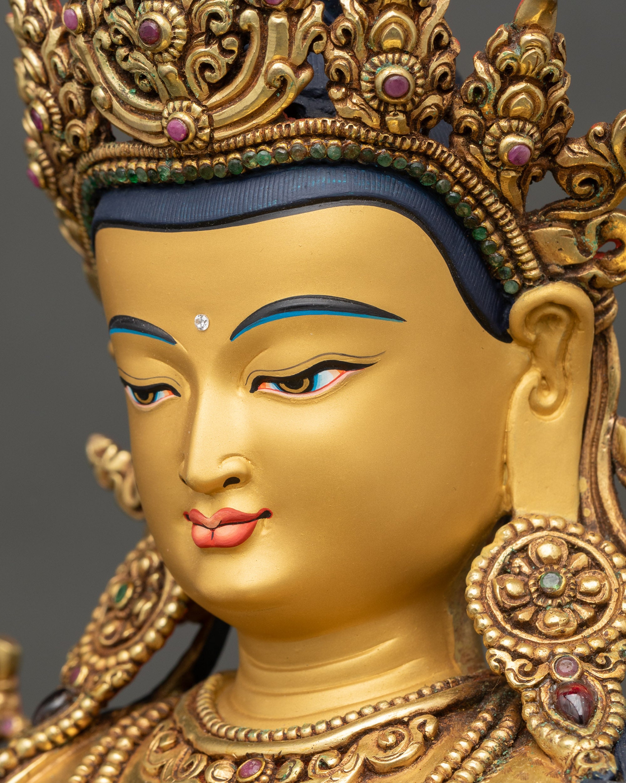 Side profile of Chenrezig face with calm expression and gilded details
