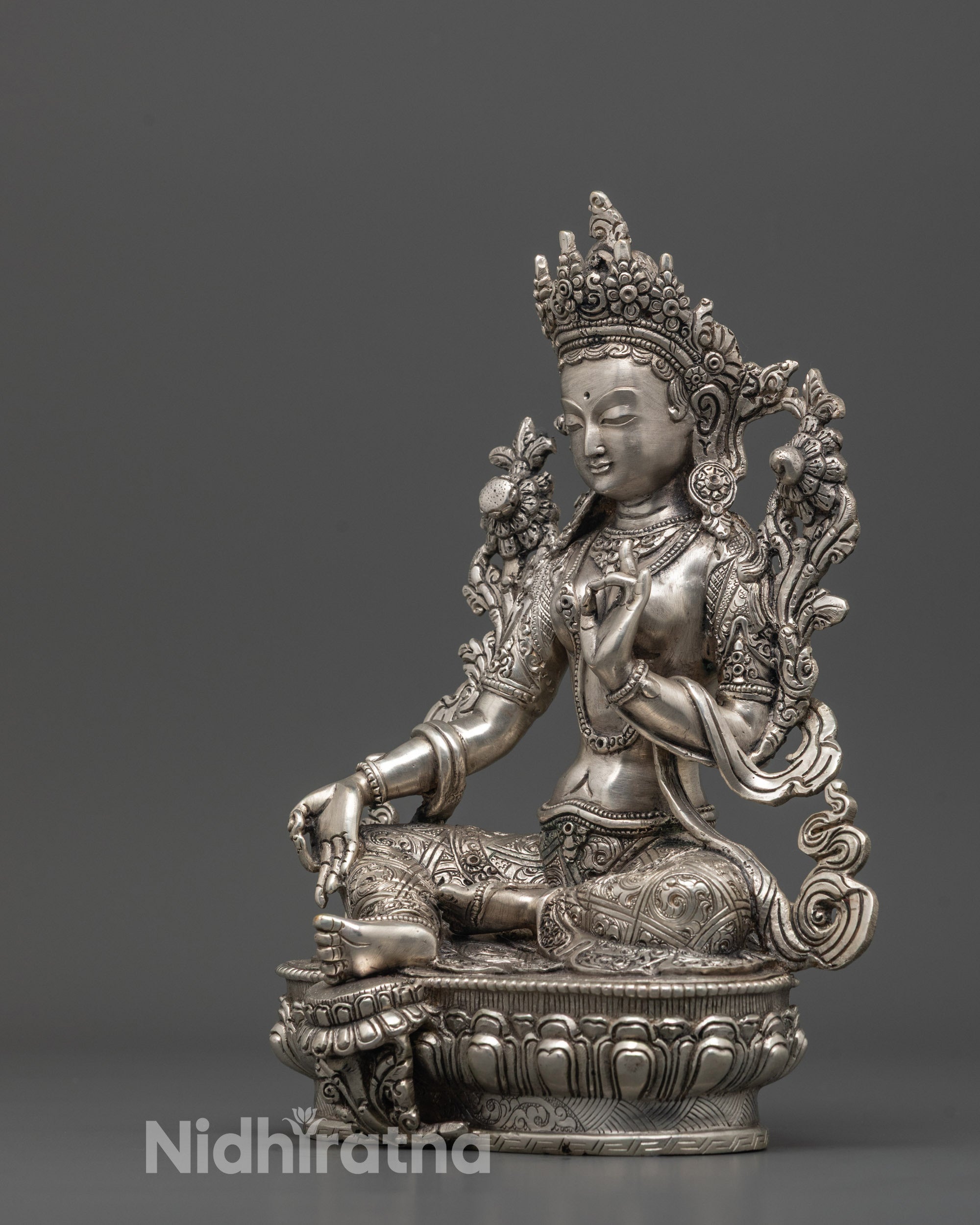 Side profile of Green Tara Statue with ornate lotus pedestal and silver-plated finish