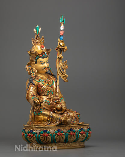 Guru Rinpoche Buddha statue showing detailed robes and lotus base in vibrant acrylic hues