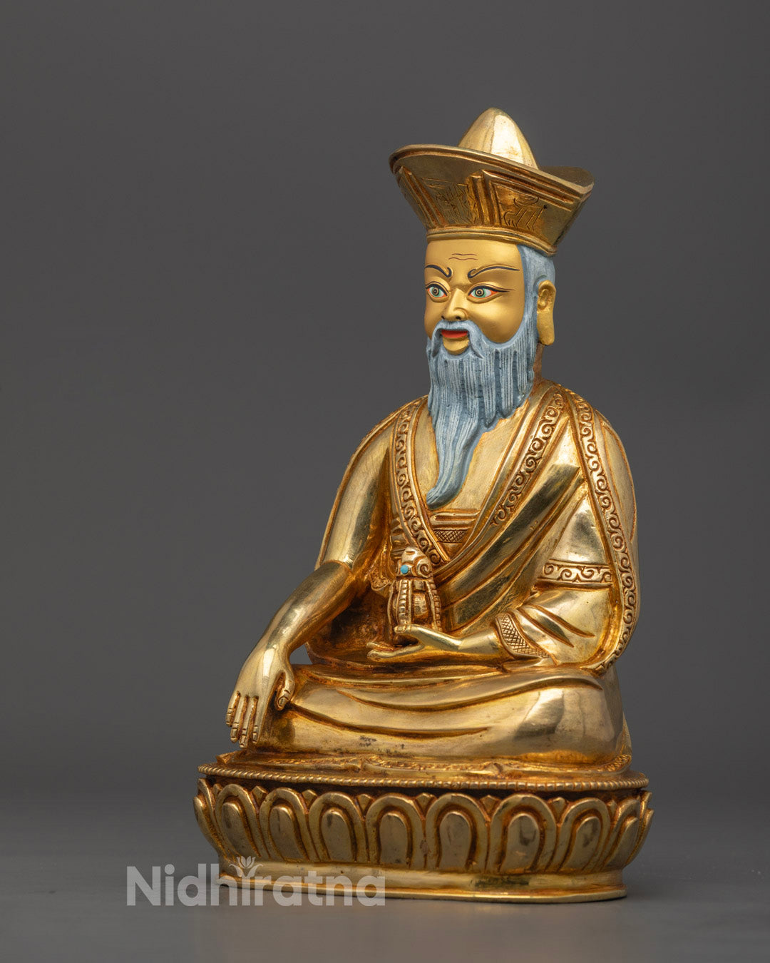 Guru Shapdum statue displaying detailed carving, sacred mudra, and gold-gilded accents on copper base.