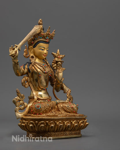 Manjushri statue holding flaming sword and Prajnaparamita Sutra, symbolizing wisdom and clarity
