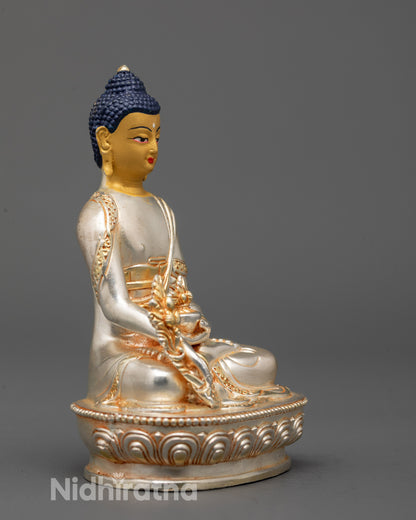 Side profile of Medicine Buddha Statue highlighting lotus pedestal and silver-plated body