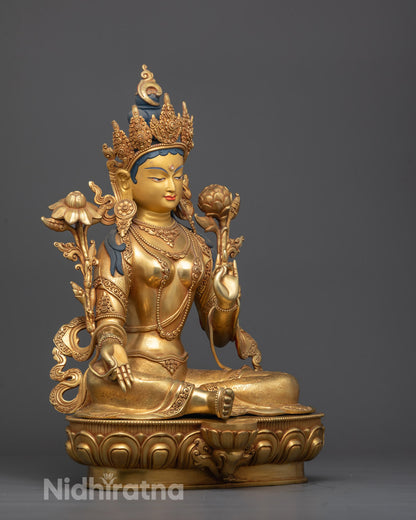 Side profile of hand-carved Green Tara sculpture highlighting intricate robe