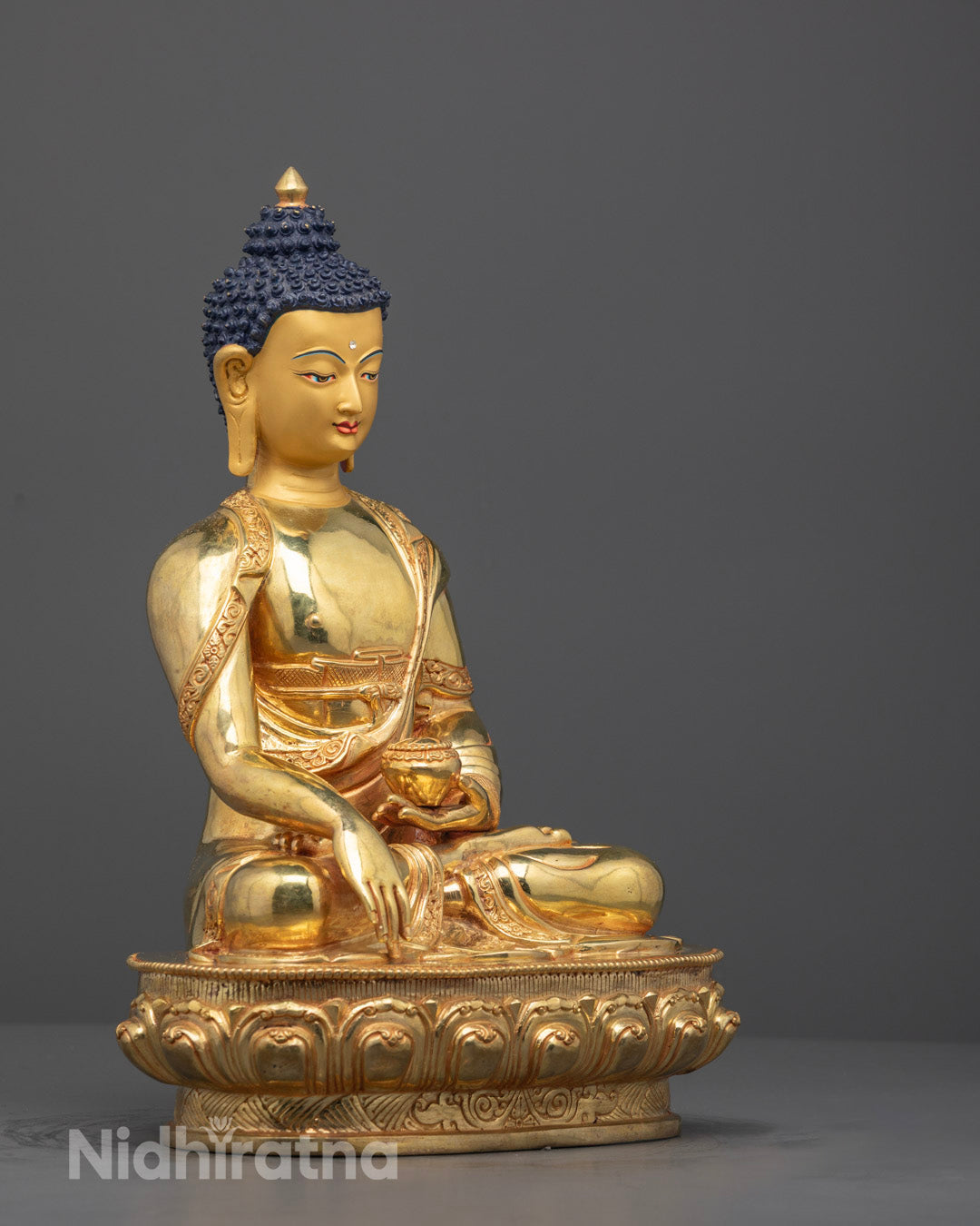 Side profile of intricately detailed Buddha sculpture with fire-gilded gold finish.